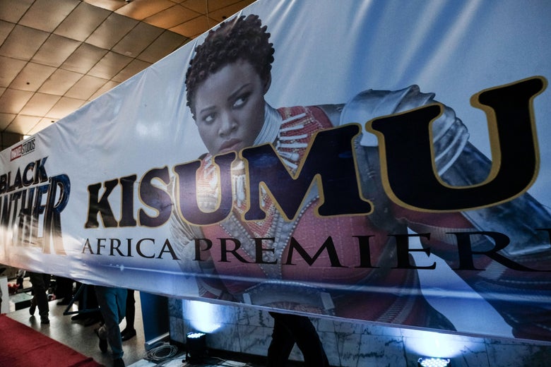 Men carry a banner with an image of Kenyan actress Lupita Nyong'o before the African premier of the Marvel film 'Black Panther' in Kisumu, Kenya, on February 13, 2018.
